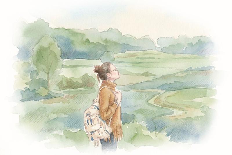 Woman standing in the middle of grass field
